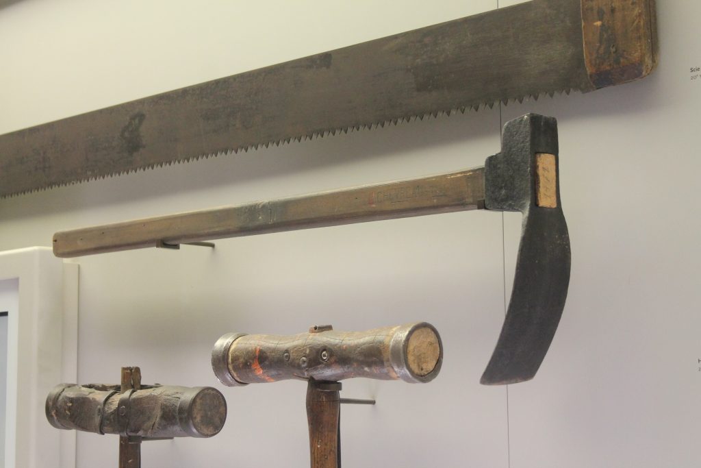 Adze on display at Musée d’histoire de Nantes – historical woodworking tool for shaping and hollowing wood