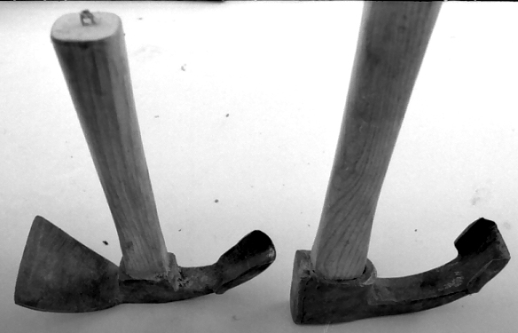 Two traditional adzes side by side – pre-industrial woodworking tools for shaping and hollowing wood