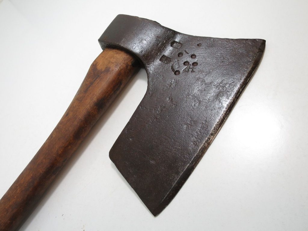Polish broadaxe on wooden surface – traditional timber hewing tool for squaring logs