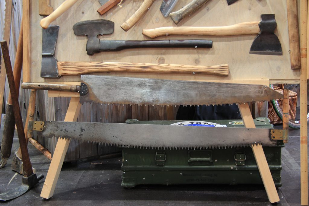 Traditional carpenter tools including handsaw – pre-industrial woodworking tools on display