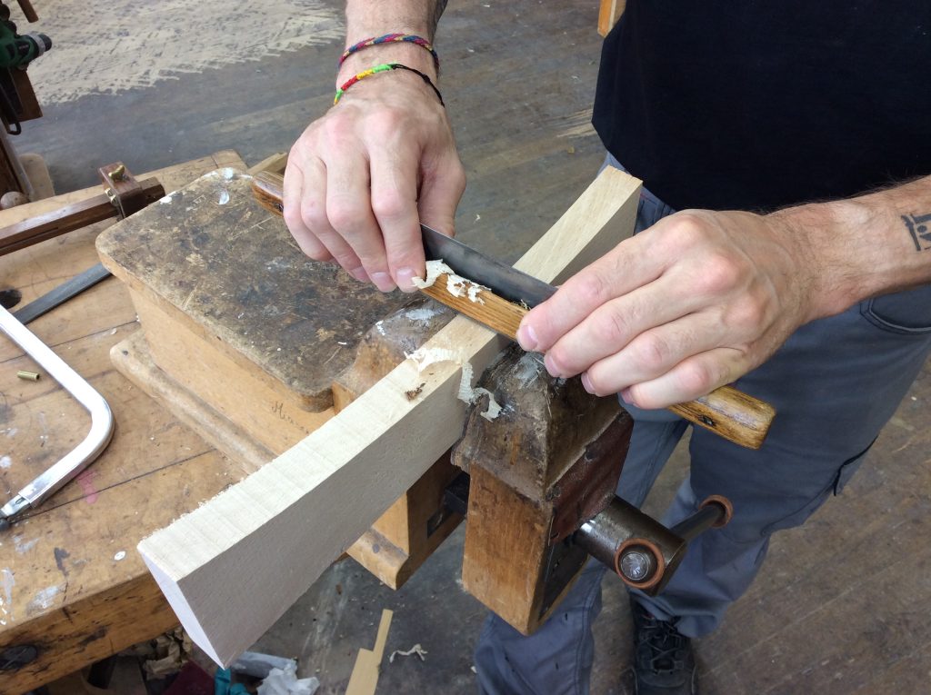 Craftsman using spokeshave at Mobilier National – traditional woodworking demonstration in France