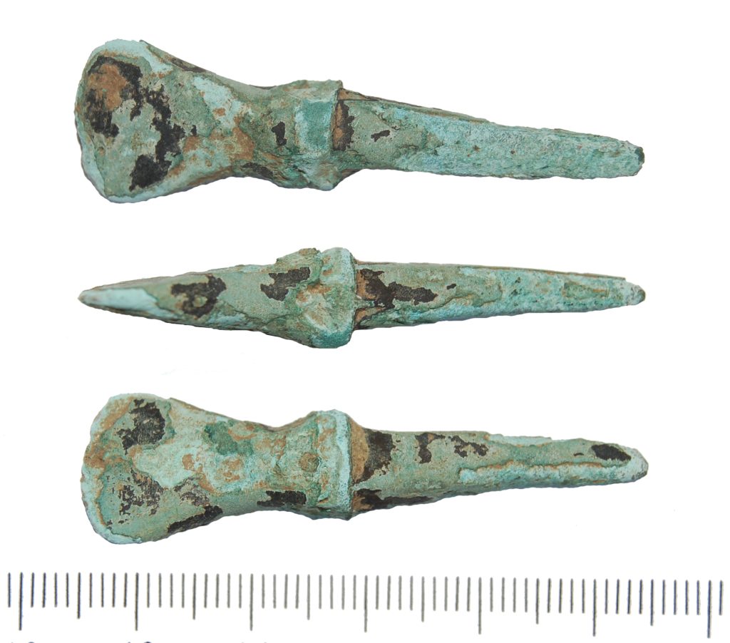 mortise Chisel – late Bronze Age copper-alloy tanged chisel on plain background