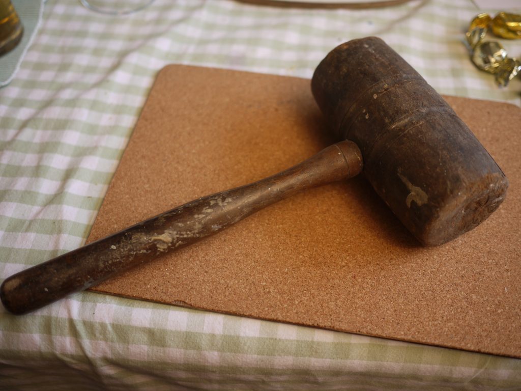 Traditional wooden mallet used in hand-tool woodworking, showing cylindrical head and handle